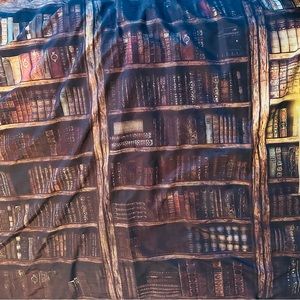 Antique book mural with broomstick and lanterns.